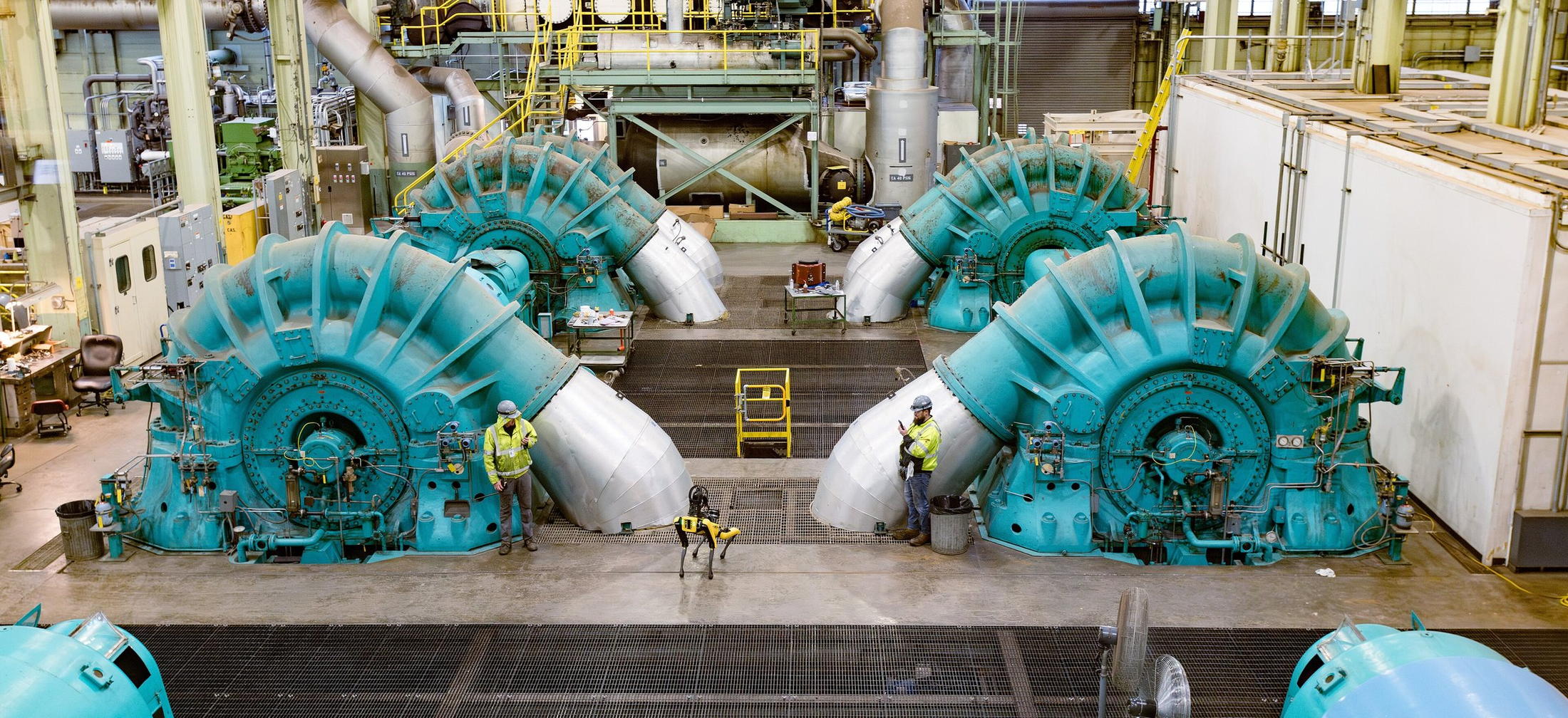 Engineers working among large industrial turbines